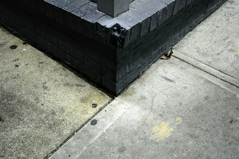 Black waterproofing membrane applied around a house foundation corner